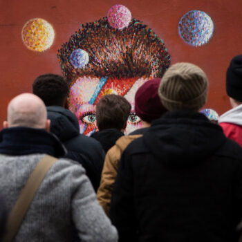 Crowd Admiring Colorful Street Art in Urban Public Space 130